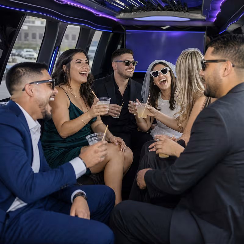 Party bus interior with wraparound leather seating and LED lighting in Fort Worth