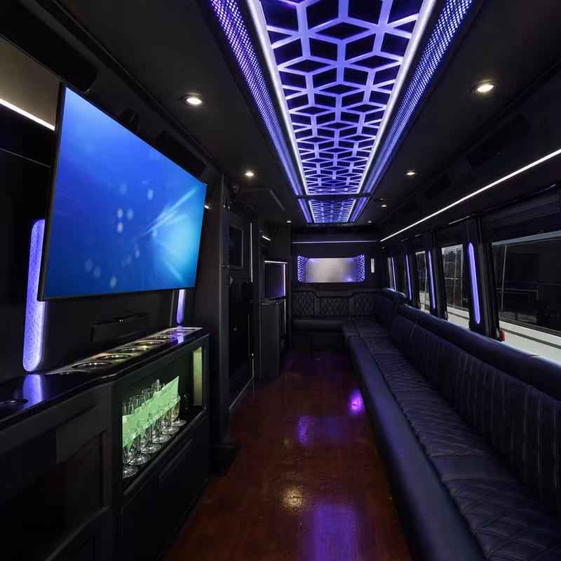 Party bus interior with wraparound leather seating and LED lighting in Fort Worth
