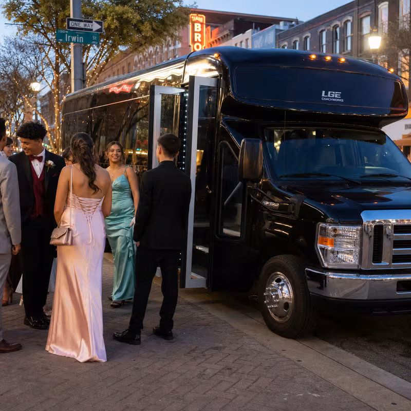 Passengers loading luggage while boarding an Fort Worth group shuttle