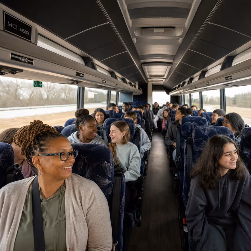Group boarding a white charter bus for School Transportation transportation in Fort Worth