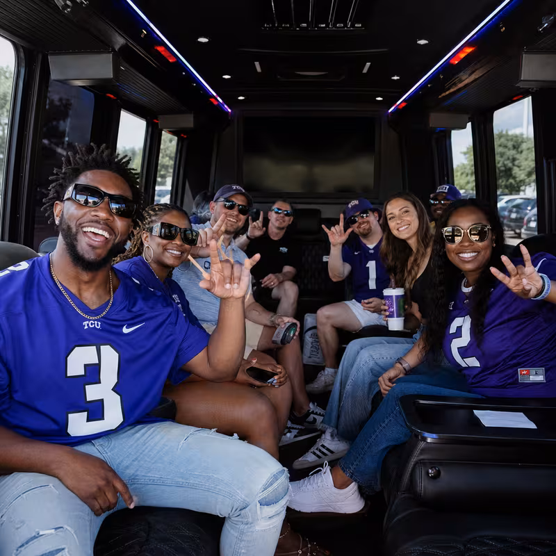 Group boarding a white charter bus for Sporting Event Transportation transportation in Fort Worth