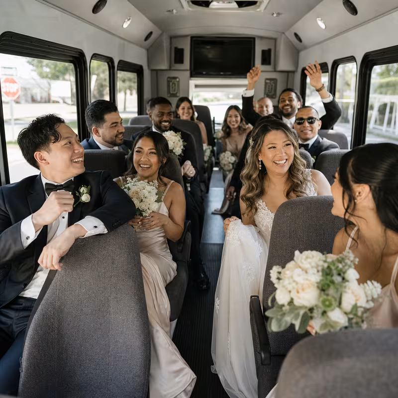 Group boarding a white charter bus for Wedding Transportation transportation in Fort Worth