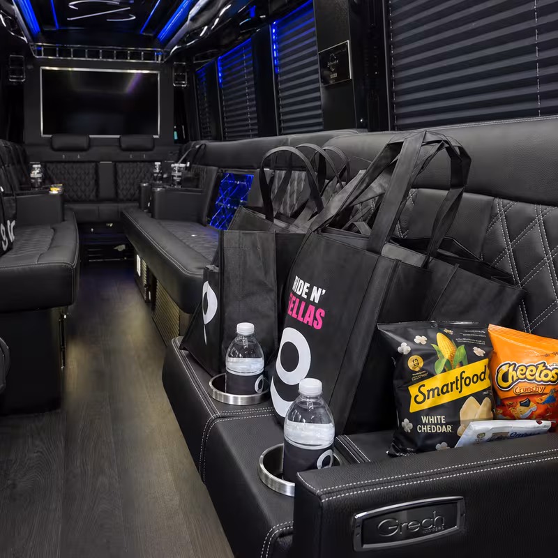 Party bus interior with wraparound leather seating and LED lighting in Fort Worth